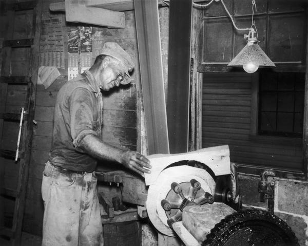 Joe Hess using a circling machine to create a barrel head at the Hess Cooperage.