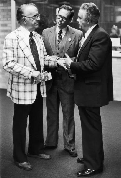 Senator Walter John Chilsen (left), and Lee Dreyfus (right), shaking hands. Man in center of image is unidentified. Chilsen was Republican state senator from Wausau, 1967-1991. Prominent in committee work on aging, agricultural and rural development, health care, consumer credit reform, and University of Wisconsin system merger. Leader of Senate Republican Caucus, 1967-72.