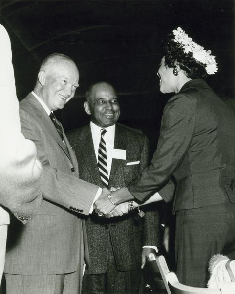 Daisy Bates shakes hands with President Eisenhower at the Summit Conference.