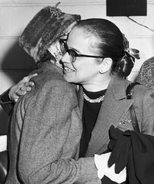 Dickey Chapelle and her Aunt Louise embrace at Idlewild Airport after Chapelle's return from Budapest, Hungary.