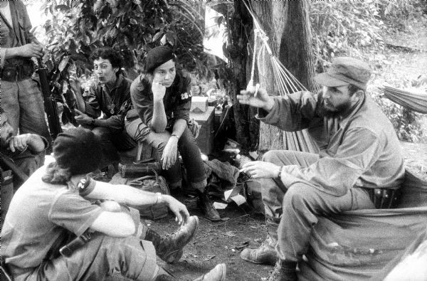 Fidel Castro is seated with his constant companion Celia Sanchez, and Vilma Espin, who sits to Castro's left. Cuba.