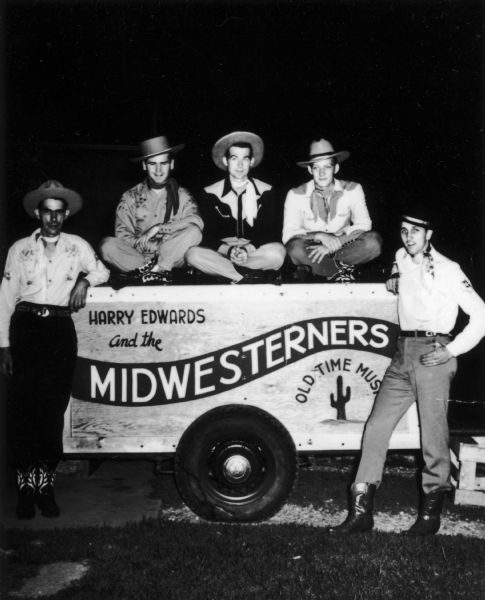 The band members of Harry Edwards and the Midwesterners pose on their trailer. From left to right are Falkerstein, Severson, Edwards, George Gilbertsen, Rollie Phillips.