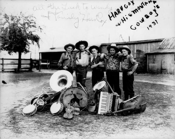 Band photograph of the five members of Harv Cox and his Montana Cowboys. The men are dressed in western wear, including cowboy hats, and are posing with their instruments.