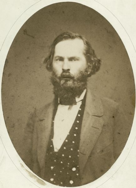 Waist-up studio portrait of Byron Paine wearing a suit.