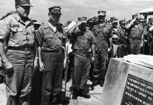 Marine Lt. General Lewis W. Walt, commanding the III Marine Amphibious Force, and Jim Lucas, representing members of the press corps in Vietnam, pause in reverence after unveiling the plaque honoring the memorial of Dickey Chapelle.