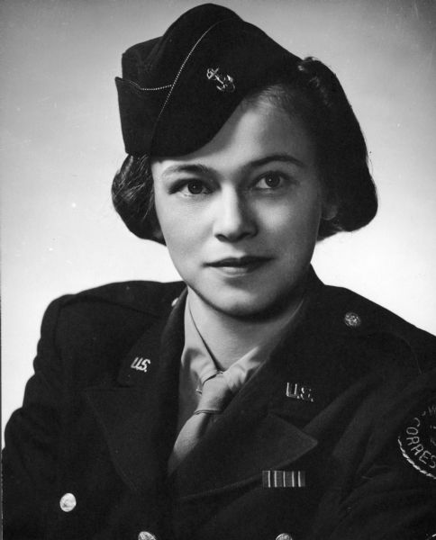 Studio portrait of Dickey Chapelle in uniform with a "war correspondent" patch on her sleeve.