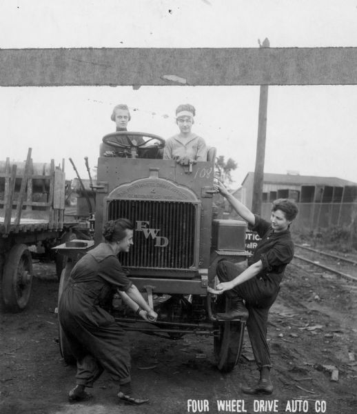 Pictured here are four of the women who joined the work force at the Four Wheel Drive Company in Clintonville in order to build trucks for the American and British armies during World War I. They helped the company to manufacture over 20,000 trucks during the war years. They are also illustrating here the vehicle's manual starter.