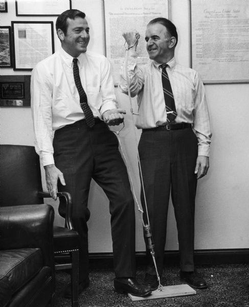 Former Olympic athlete Bob Matthias (left) and Republican Senator Chilsen and using exercise equipment. Matthias was also a Republican Congressman from California. Chilsen was Republican state senator from Wausau, 1967-1991. Prominent in committee work on aging, agricultural and rural development, health care, consumer credit reform, and University of Wisconsin system merger. Leader of Senate Republican Caucus, 1967-72.
