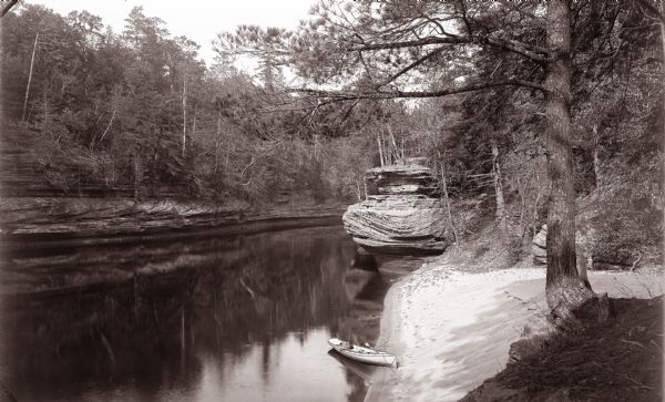 Elevated view of the mouth of Chapel Gorge Beach showing a canoe at the shore.