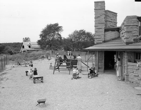 Children playing outside the nursery school classroom at the First Unitarian Society Meeting House. The building was designed by Frank Lloyd Wright.