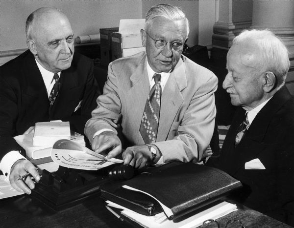 Seated from left to right are University of Wisconsin President E.B. Fred, Governor Oscar Rennebohm, and UW Board of Regents President F.J. Sensenbrenner.
