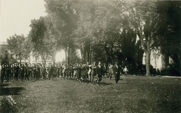 A large group of students walk down Bascom Hill.