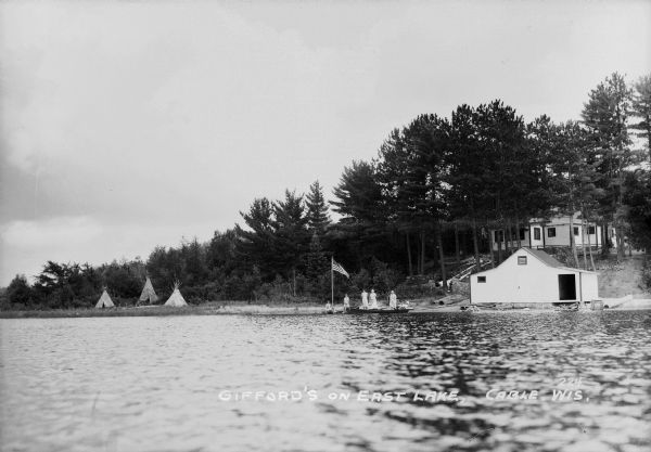 People on the shore of East Lake (now called Lake Tahkodah) by the Gifford residence, with tipis in the distance.