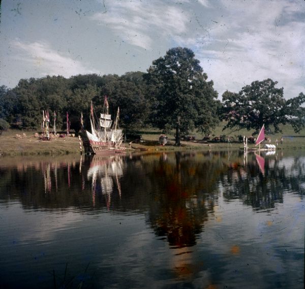 Model boats floating on the pond at Taliesin, possibly during a party or celebration. Taliesin was the summer home of architect Frank Lloyd Wright and the Taliesin Fellowship. Taliesin is located in the vicinity of Spring Green, Wisconsin.