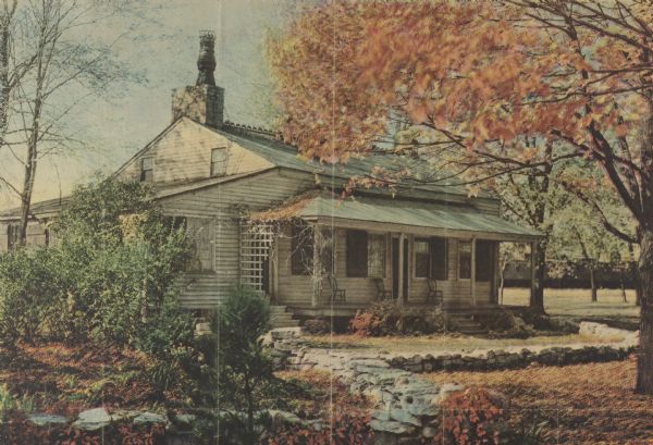 The Roi-Porlier-Tank Cottage with trees scattered about, and a low, stone wall in the front. The caption accompanying this image reads as follows: "Tank Cottage, at Green Bay, the oldest house in Wisconsin. Joseph Roi, a French voyageur, built the home about 1785 and lived in it for many years. It takes its name from Nels Otto Tank, a Norwegian, who bought the cottage in 1850 and founded a Moravian settlement near Green Bay. The cottage was purchased by the Green Bay Historical society and the South Side Improvement society about 30 years ago and moved to Union Park, where it is visited annually by thousands of people from all parts of Wisconsin."