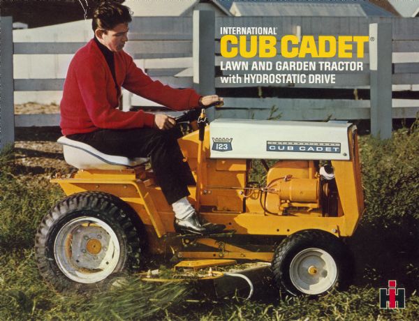 Front cover of a brochure advertising the International Cub Cadet Hydrostatic 123 lawn and garden tractor. The color illustration features a man in a cardigan and dress shoes mowing in front of a fence.