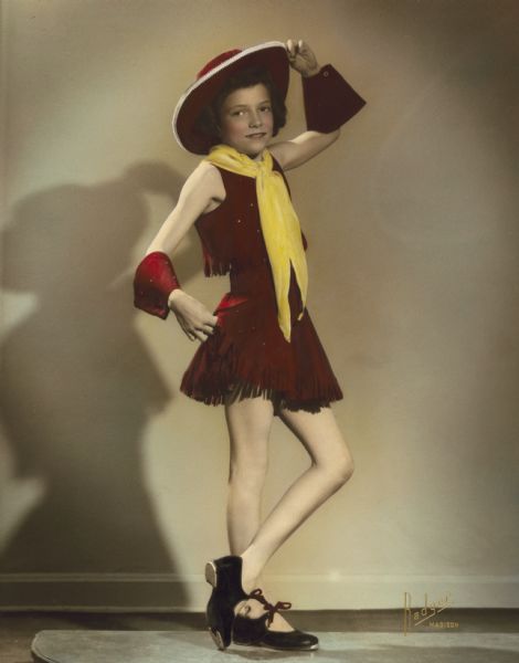 Janet Phyllis Wheeler (later Mrs. Herold), a student at the Kehl School of Dance, wears a cowgirl oufit for a tap dance routine she performed in the school's 1949 dance recital.  The costume (2005.130.1), but not the hat or tap shoes, are now part of the Wisconsin Historical Museum's collection.