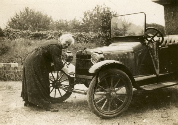 Dr. Anna Howard Shaw (1847-1919) turning the crank of her car. Dr. Shaw was an ordained Methodist minister, physician, temperance lecturer, woman's suffrage orator and peace advocate. She was member of a Big Rapids area pioneer family and friend and colleague of Susan B. Anthony. She completed her early education at Big Rapids High School and Albion College. She was the first woman to receive the highest civilian Presidential citation, the Distinguished Service Medal, for her international efforts on behalf of world peace. She is recognized in the Michigan Women's Hall of Fame. 
