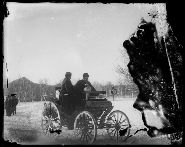 Automobile with two men in it.