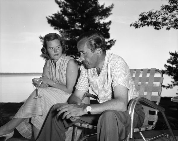 Edward R. Murrow, seated next to an unidentified woman.