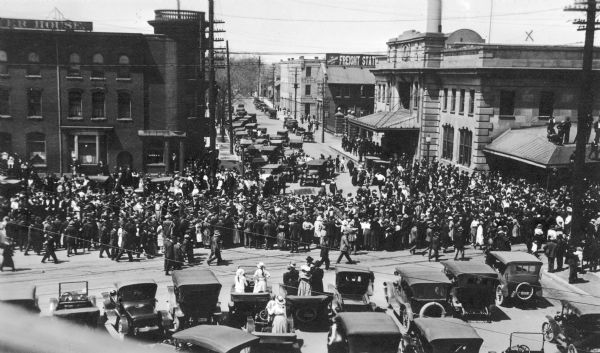 A crowd watching as drafted men leave Madison via the Chicago Northwestern railroad station.