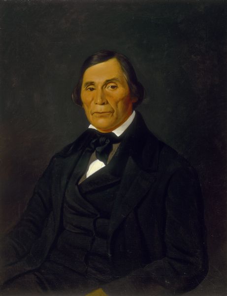 Waist-up portrait of Daniel Bread wearing a suit.