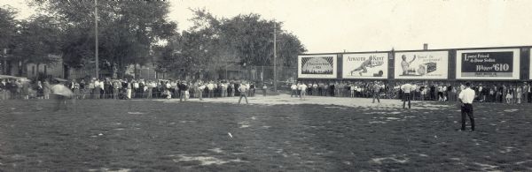 Softball tournament at old Barry Park. There are billboards along the infield between third base and home.