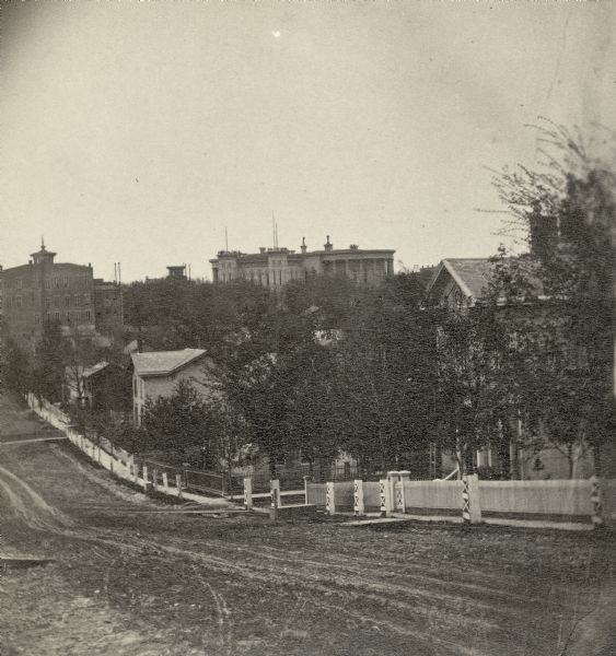 View of fence-lined Pinckney Street from Gilman Street including the Burrows House.