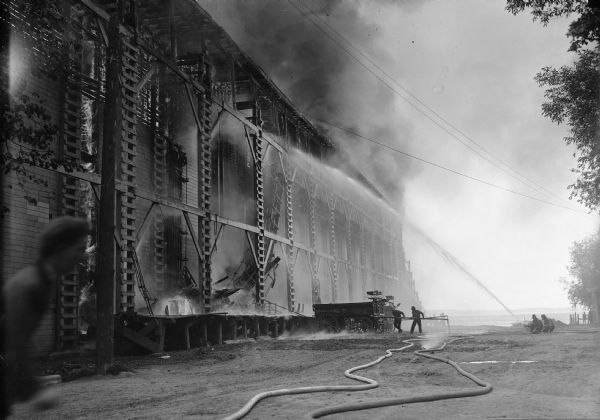 Several men try to extinquish a fire in an ice house, which is known as the Conklin Fire.