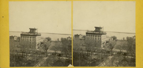Stereograph of Madison looking southeast across Lake Monona from the Capitol featuring the Vilas House hotel.