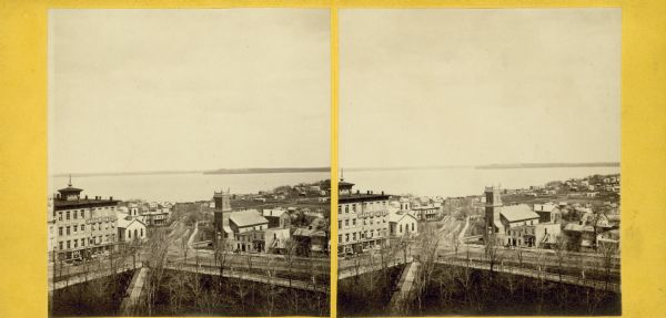 Stereograph of an elevated view looking down at North Hamilton Street, showing the State Journal building on the lefthand side.