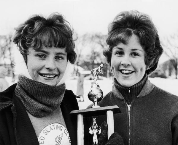 Junior Girls Speed Skaters Co-Champs, Andrea Melin, of Superior, Wisconsin, and Linda Schubert, of West Allis, posing together with their trophy.