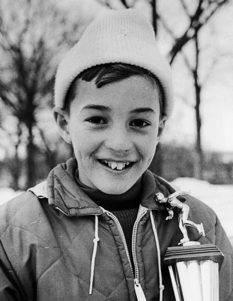 George Beronja of West Allis posing with a trophy for speed skating.