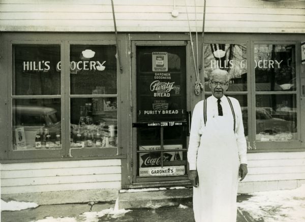 John W. Hill, owner of Hill's Grocery at 649 East Dayton Street, poses in front of his business, which he bought with his wife Amanda on November 23, 1915.