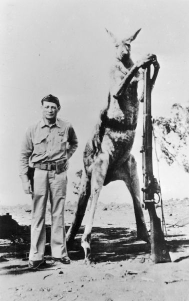 Altered photograph in which Lloyd Lebrbas appears with a giant militia kangaroo which is leaning on a gun.