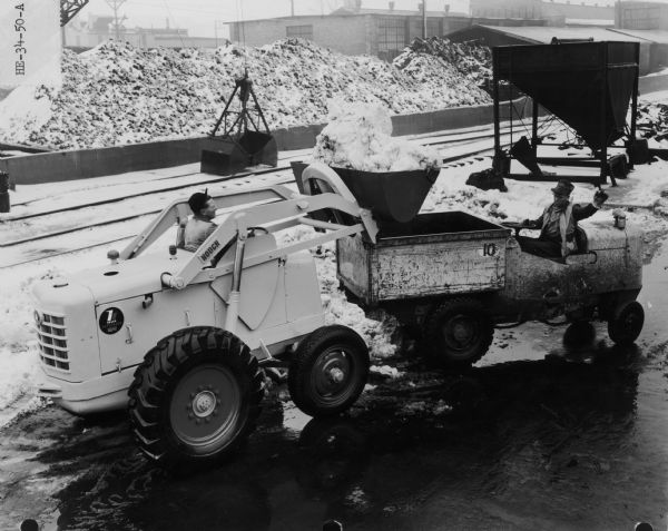 Hough HE Payloader loading snow into a truck. The HE was built by Frank G. Hough Company, a Libertyville, Illinois, manufacturer of construction equipment.