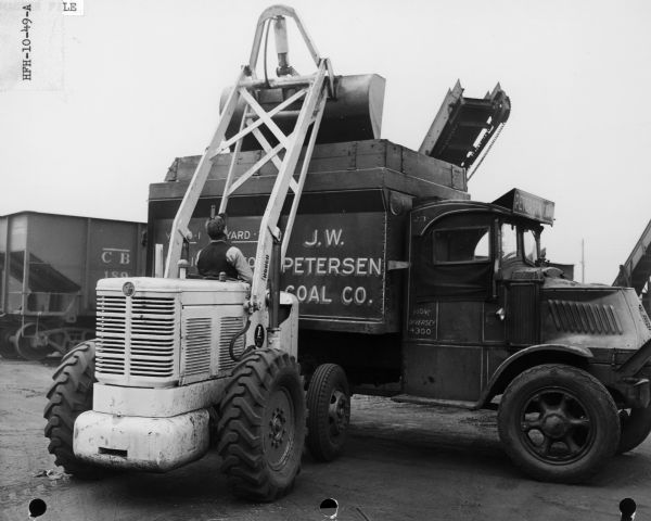 Hough HFH Payloader loading coal into a J.W. Petersen Company truck. The HFH was built by the Frank G. Hough Company, manufacturers of construction equipment in Libertyville, Illinois.