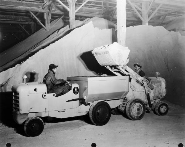 Hough Payloader with buggy being loaded by another machine. According to the original caption, the machines were the property of the American Agricultural Chemical Company of Cleveland, Ohio. The payloader was built by the Frank G. Hough Company of Libertyville, Illinois, which was purchased by International Harvester in 1952.