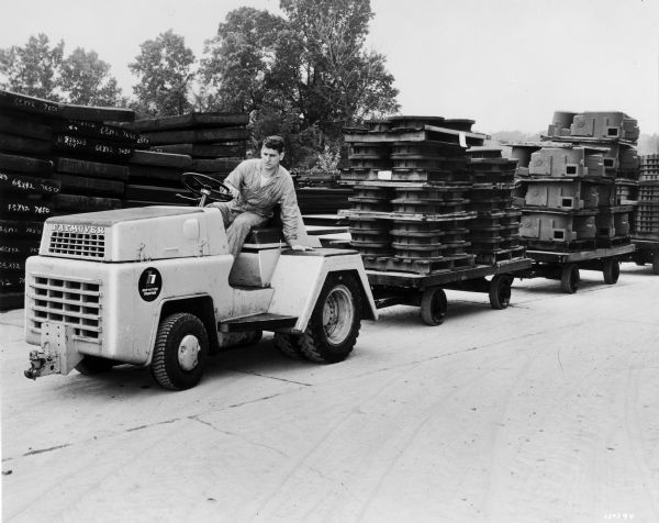 International Paymover model TC-60 pulling carts of parts.  The TC-60 was built by Hough, the construction equipment subsidiary of International Harvester.
