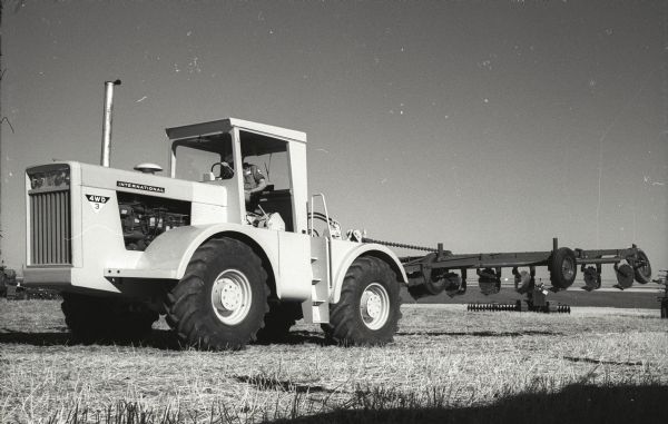 Experimental four-wheel drive tractor (4WD-3) at a field demonstration near Great Falls, Montana. The demonstration took place on the farm of Walter Mehmke, a collector with over fifty antique tractors.