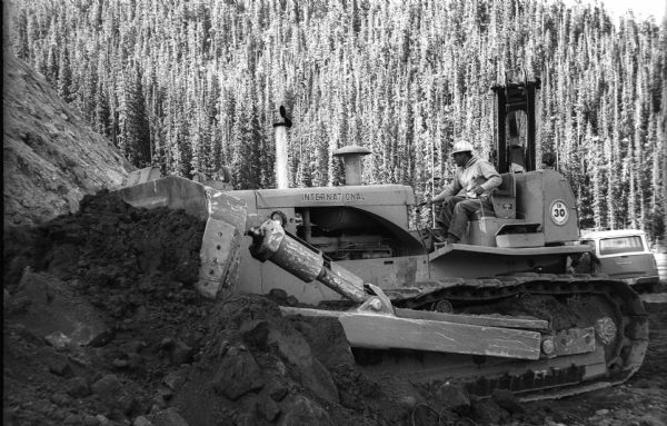 International TD-30 crawler tractor (TracTracTor) working to widen U.S. Highway 40 near Berthoud Pass in Colorado. The highway wound through the Rocky Mountains. The TD-30 was a pre-production model dispatched to the scene for a "field test" by International Harvester.