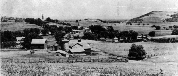 View down hill of the Enos Lloyd Jones farm with Hillside Home School and Romeo and Juliet in the background.