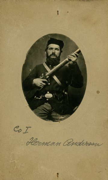 An oval-framed, seated studio portrait of Anderson Herman, a private in Company I, 15th Wisconsin Infantry in uniform, holding a musket across his chest. The following information was obtained from the Regimental and Descriptive Rolls, Volume 20: He resided in Scandinavia, Wisconsin. On November 11, 1861, he enlisted in Scandinavia, Wisconsin and was mustered into service on December 20, 1861, in Madison, Wisconsin at the age of 35. In December 1863 he was detached from the company to serve as a baker in Stevenson, Alabama. He survived the war and mustered out with Company I on February 10, 1865, at Chattanooga, Tennessee.