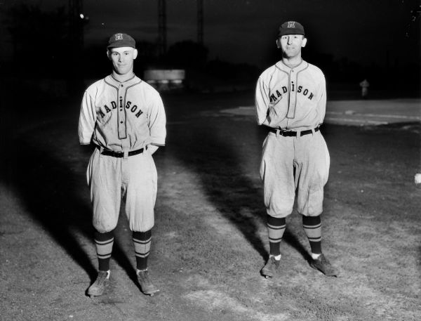 Joe Hady and Alvah Elliott, Madison Blues baseball players, in uniform, standing with their hands behind their backs.
