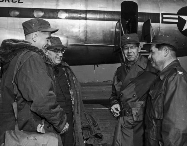 Lieutenant Colonel Rosengren and Captain George Pierce greet Dwight Martin and Henry Luce upon their arrival in Seoul, Korea.