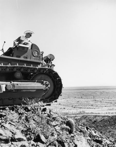 Man on a TD-24 crawler tractor looks down over International Harvester's Phoenix Proving Ground. Opened in 1947, the proving ground was used by International Harvester through the 1970's to test trucks and construction equipment under harsh desert conditions.