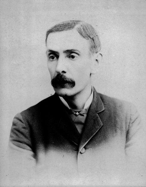 Portrait of Horace Palmer with moustache and suit. A portion of his hair appears to be drawn onto the photograph.