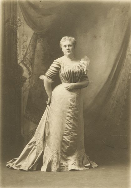 Full-length studio portrait of Mary Louisa Atwood standing and wearing a long dress, age 47.