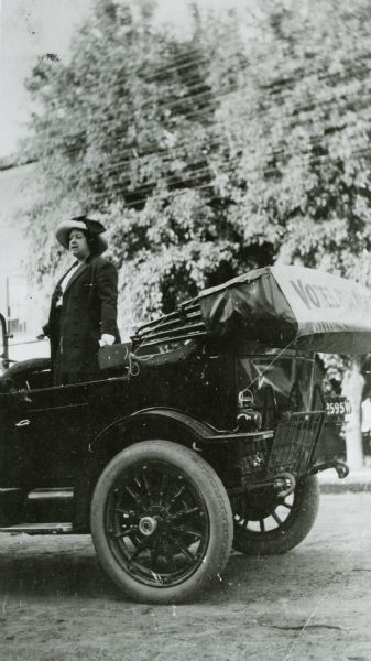 Rachel S. Jastrow campaigning for women's suffrage from the back of an automobile with a banner reading "Votes for Women."