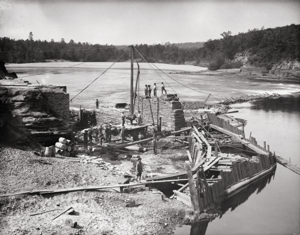 Elevated view of men in the midst of dam construction.